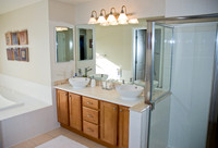 Master Bath: new corian countertop with dual vessel sinks and all-brass faucets and lighting